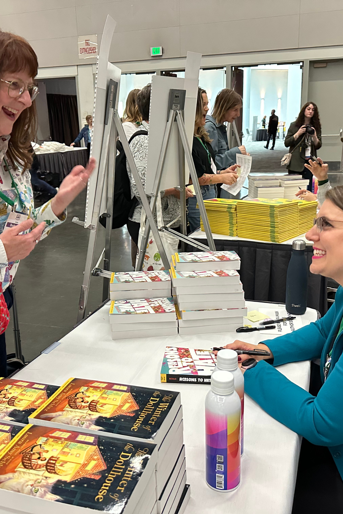 Susan Metallo converses with an excited fan in a book signing line.
